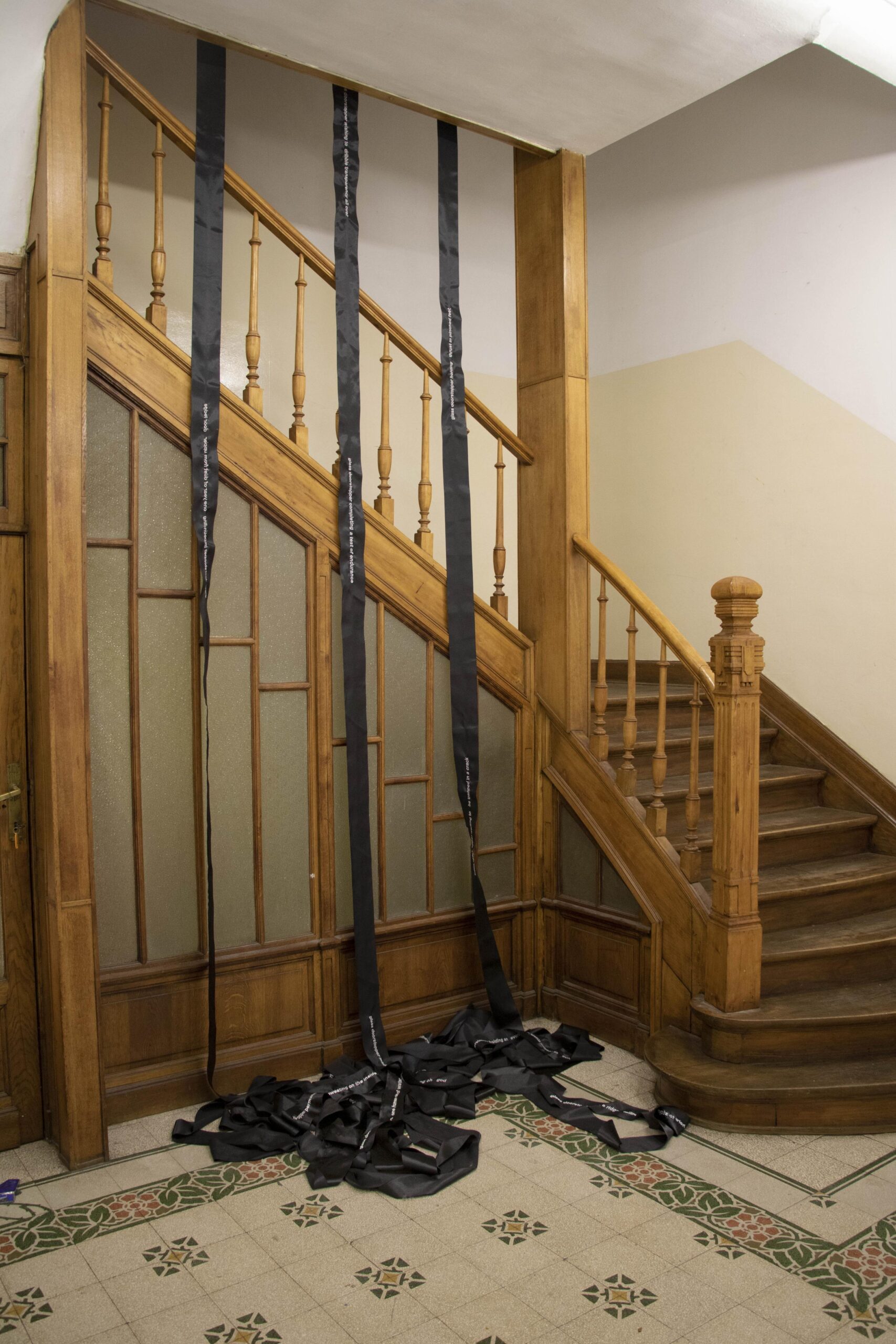 70 meter long poem embroidered on black satin band