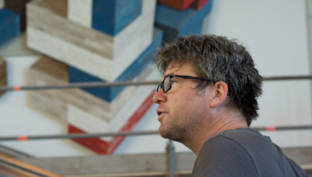 Portrait of Ron van der Ende at the installation of a large site-specific bas relief at Erasmus MC Main Entrance in Rotterdam