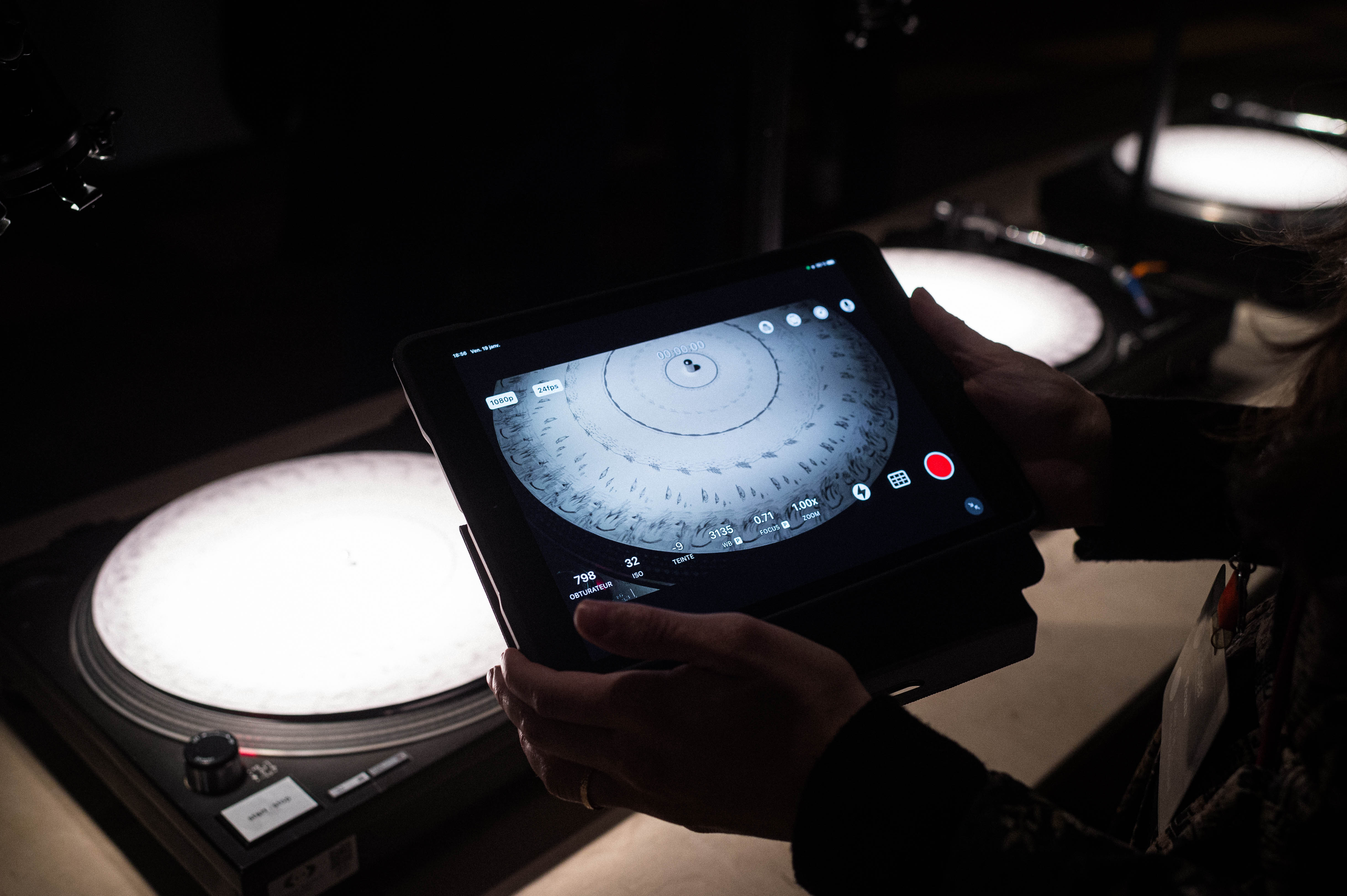 ORBIT installation, 2020, projected film, discs on turntables, cellphones, 10 looping videos on a mo